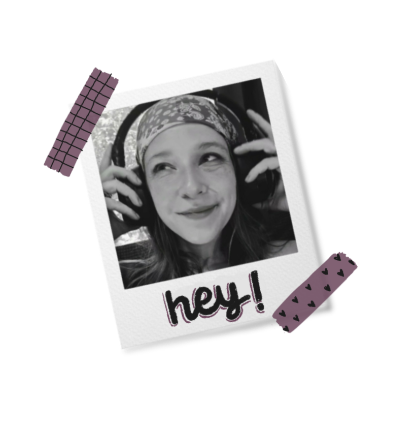 binzy wearing headphones and a patterned bandana — a black-and-white polaroid taped to a dark surface